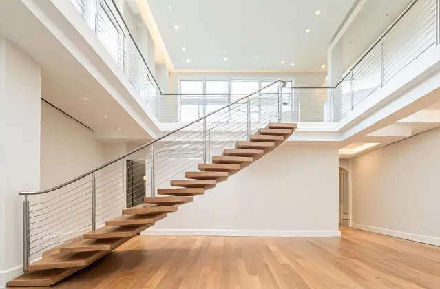 Custom home floating stair with cable rail