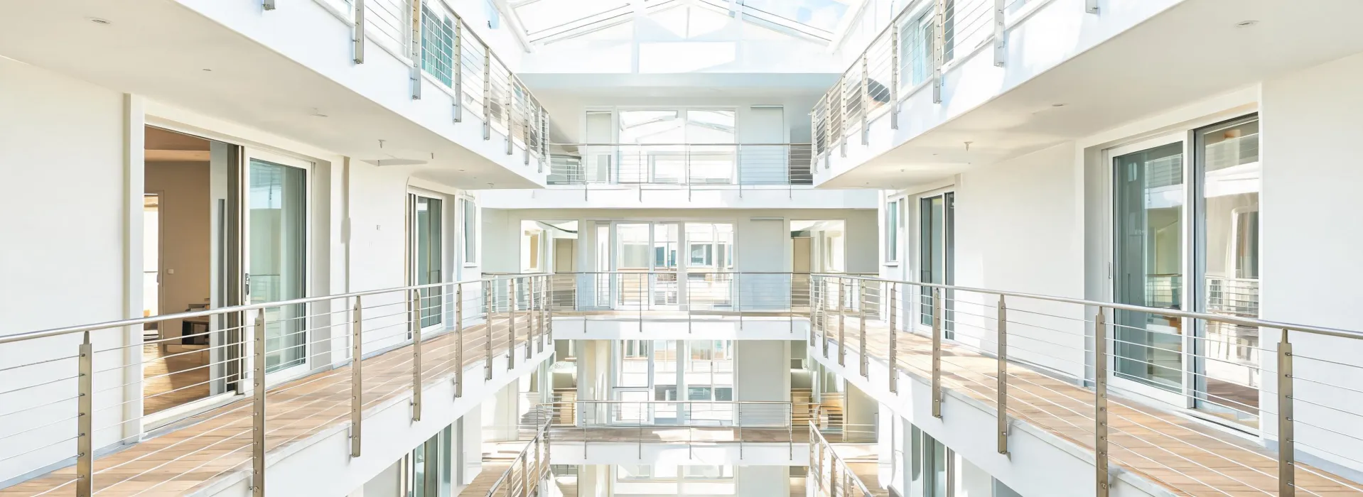 Modern multifamily atrium with cable railing balconies